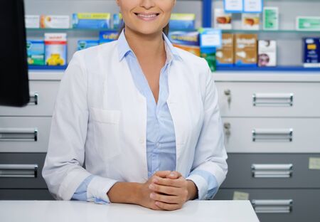 Beautiful smiling young woman pharmacist doing his work in pharmacy.の写真素材