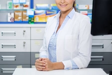 Beautiful smiling young woman pharmacist doing his work in pharmacy.の写真素材