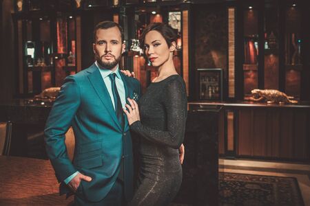 Well-dressed couple in luxury apartment interior.の写真素材