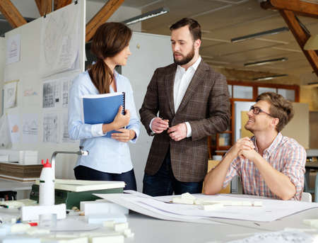 Confident team of engineers working together in a architect studio.の写真素材
