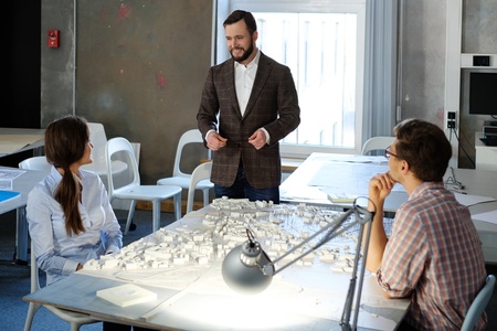 Confident team of engineers working together in a architect studio.の写真素材