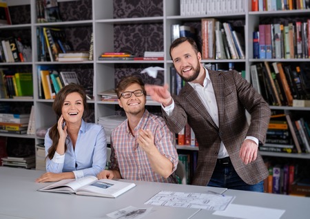 Confident team of engineers having fun in a architect studio.の写真素材