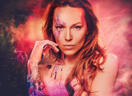 Portrait of beautiful woman with creative makeup on colored background.の写真素材