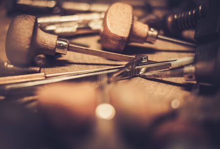 Different goldsmiths tools on the goldsmith workplace.の写真素材