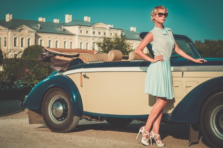 Beautiful lady near classic convertible