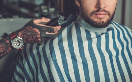 Confident man visiting hairstylist in barber shop.の写真素材