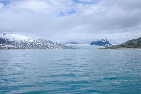 Scenic view of Styggevatnet with snowy mountains on the background. Norway.の写真素材