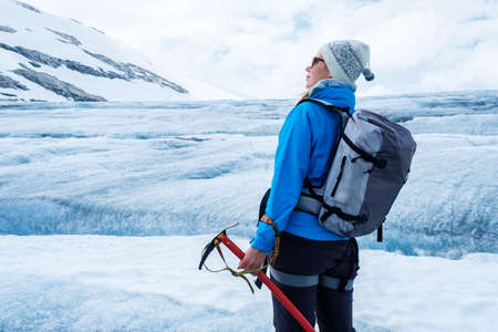 Woman climber standing on Jostedalsbreen glacier. Norway.の写真素材