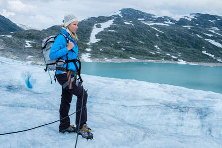 Woman climber standing on Jostedalsbreen glacier. Norway.の写真素材