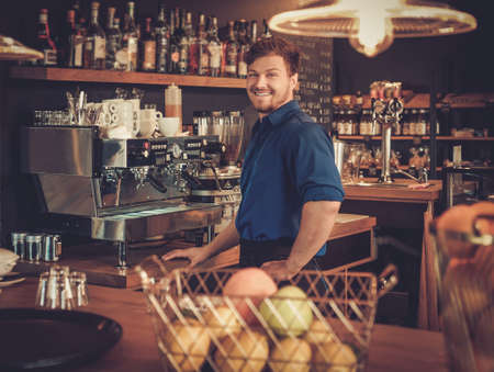 Barman having fun at bar counter in bakery.の写真素材