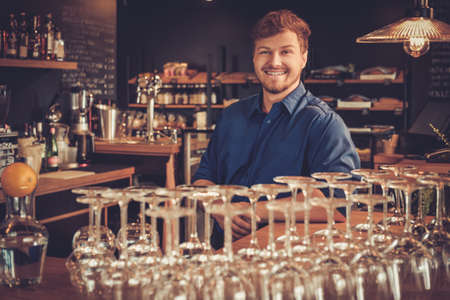 Barman having fun at bar counter in bakery.