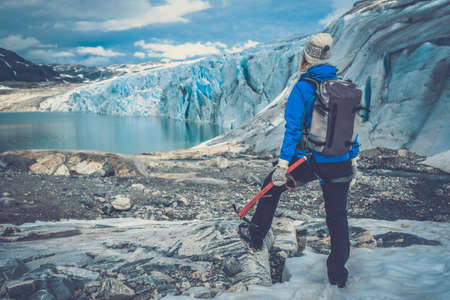 Woman climber standing near Jostedalsbreen glacier. Norway.の写真素材
