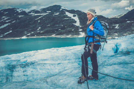 Woman climber standing on Jostedalsbreen glacier. Norway.の写真素材