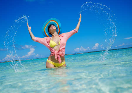 Woman in bikini sunbathing on the beach in Exuma, Bahamas.の写真素材