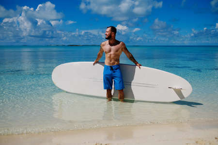 Man with Stand Up Paddle Board on the beach in Bahamas.の写真素材