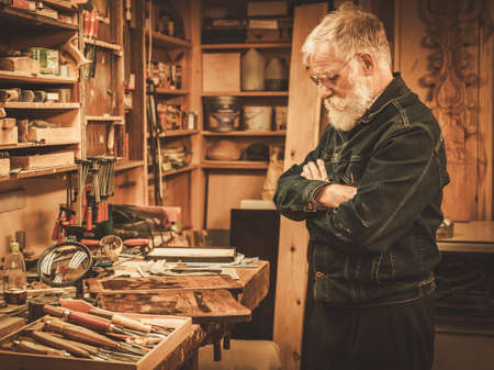 Portrait of senior restorer in his workshop.の写真素材