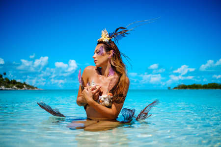Portrait of exotic fantasy mermaid in blue ocean.の写真素材