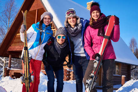 Best friends spend winter holidays at mountain cottage.の写真素材