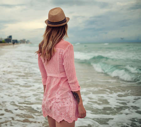 Beautiful woman walking along the South beach, Miami, USAの写真素材