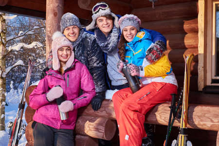 Best friends spend winter holidays at mountain cottage.の写真素材