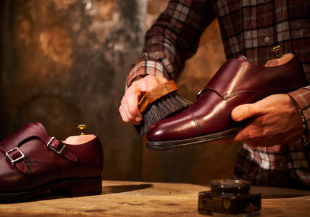 Man polishing leather shoes with brush.の写真素材