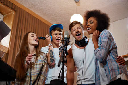 Multiracial music band performing in a recording studio.の写真素材