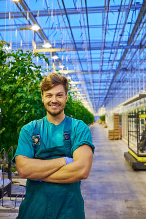 Friendly farmer at work in greenhouse.の写真素材