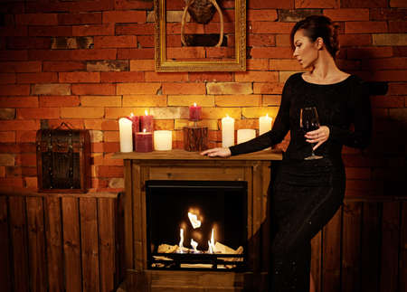 Well-dressed woman in cozy home interior.の写真素材