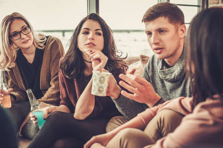 Group of multi ethnic young friends having fun in home interior.の写真素材