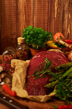 Fresh raw meat with herbs, spices and vegetables.