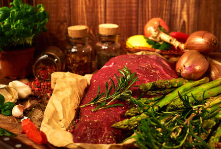 Fresh raw meat with herbs, spices and vegetables.の写真素材