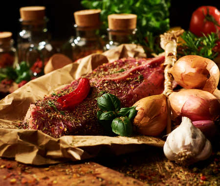 Fresh raw meat with herbs, spices and vegetables.の写真素材