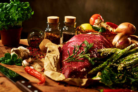 Fresh raw meat with herbs, spices and vegetablesの写真素材