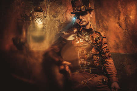 Portrait of steampunk man with various mechanical devices on vintage steampunk backgroundの写真素材