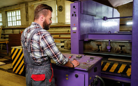 Carpenter doing his job in carpentry workshop