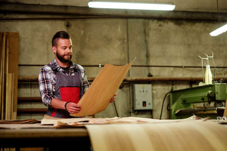 Carpenter doing his job in carpentry workshopの写真素材