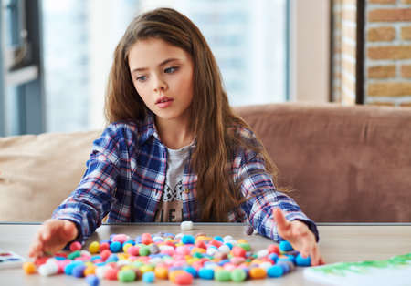 Beautiful little girl playing with colored set for creativityの写真素材