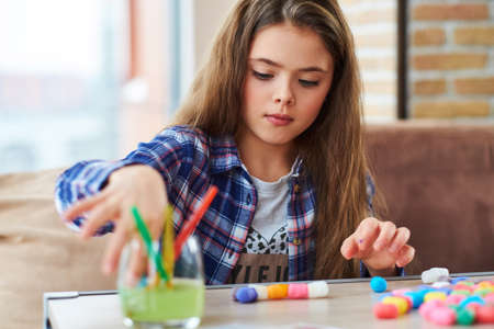 Beautiful little girl playing with colored set for creativityの写真素材