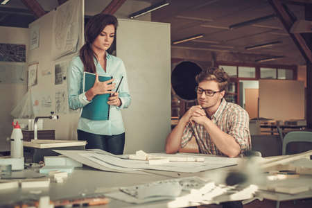 Confident team of engineers working together in a architect studio.