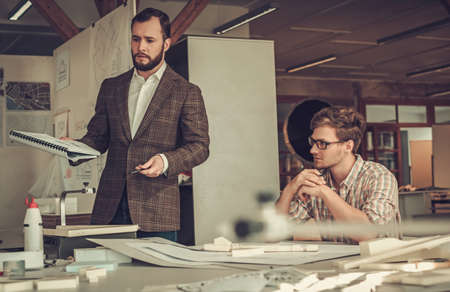 Confident team of engineers working together in a architect studio.の写真素材