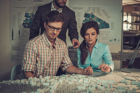 Confident team of engineers working together in a architect studio.