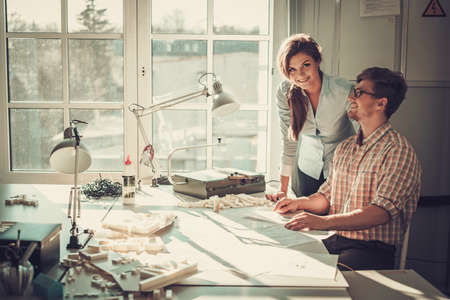 Confident team of engineers working together in a architect studio.