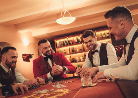 Group of upper class men playing poker in gentlemens clubの写真素材