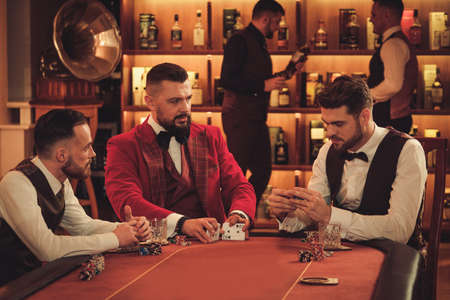 Group of upper class men playing poker in gentlemens clubの写真素材
