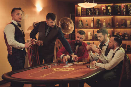 Group of upper class men playing poker in gentlemens clubの写真素材