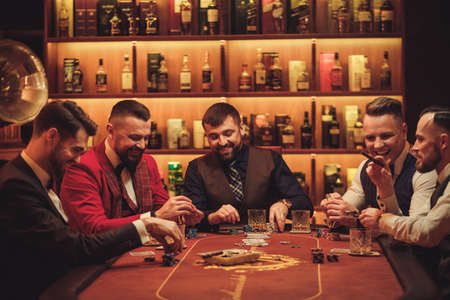 Group of upper class men playing poker in gentlemens clubの写真素材