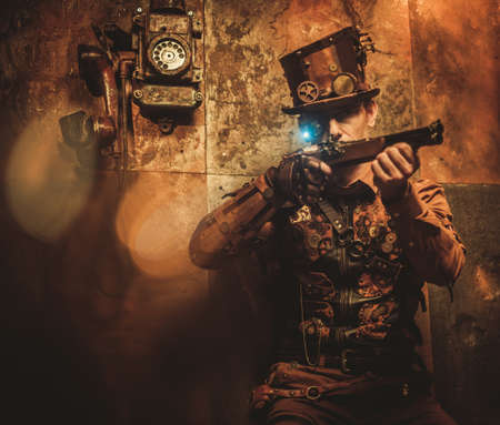steampunk style man with various mechanical devices on vintage steampunk backgroundの写真素材