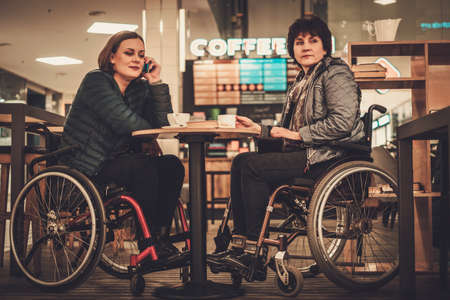 Two physically challenged women in a cafeの写真素材