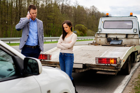 Couple near broken car on a roadsideの写真素材