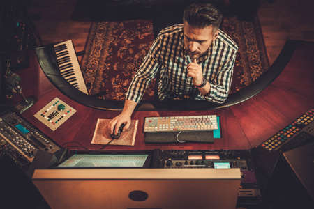 Sound engineer working in boutique recording studio.